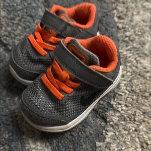 Grey and orange Nike tennis shoes